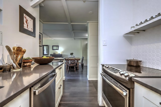 kitchen with white cabinets, stainless steel appliances, dark wood-type flooring, and stainless steel counters