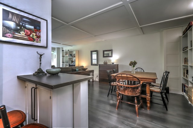 dining room with coffered ceiling and dark hardwood / wood-style flooring