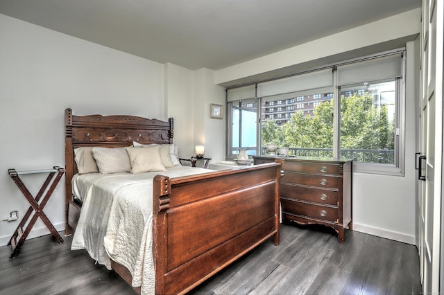 bedroom featuring dark wood-type flooring and baseboards