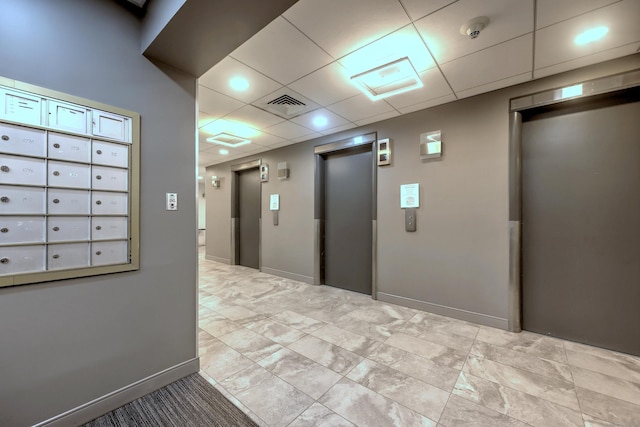 corridor featuring a paneled ceiling, elevator, and baseboards