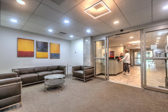 living room with recessed lighting, visible vents, carpet floors, and a paneled ceiling