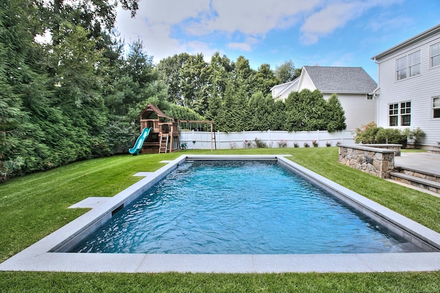 view of pool featuring a yard, a fenced in pool, a fenced backyard, and a playground