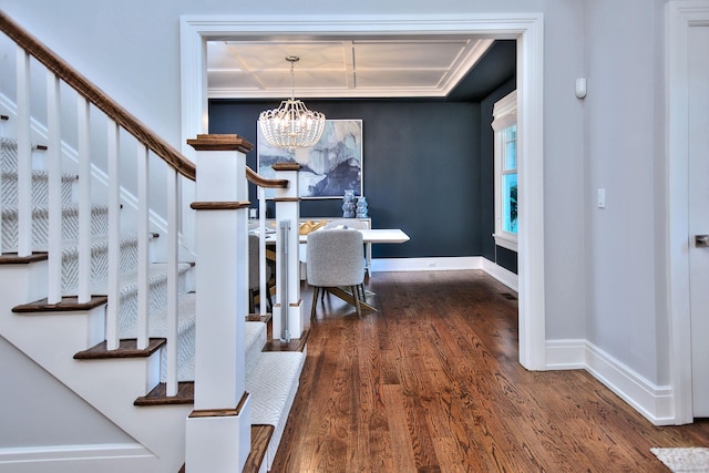 dining space featuring stairway, wood finished floors, baseboards, and a chandelier