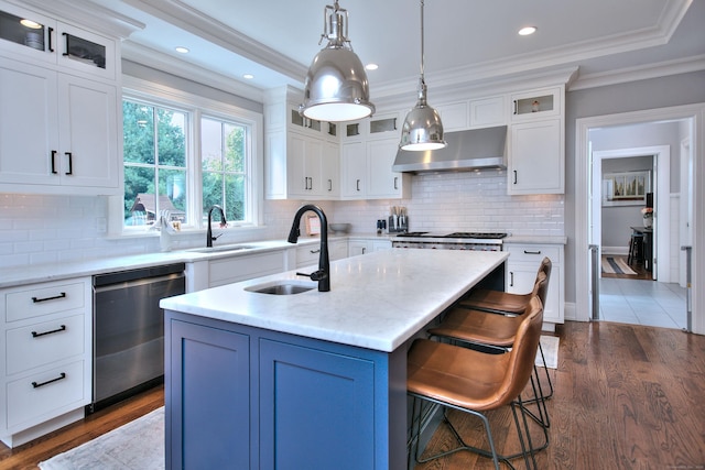 kitchen featuring ornamental molding, appliances with stainless steel finishes, wall chimney exhaust hood, and a sink