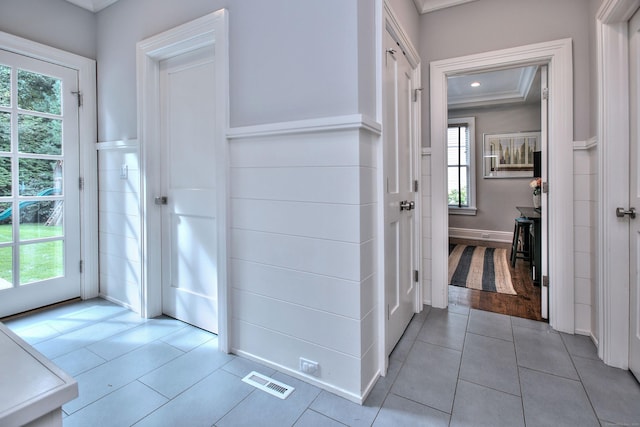 hall with visible vents, crown molding, light tile patterned floors, recessed lighting, and a raised ceiling