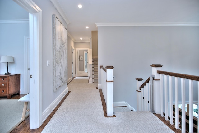 hallway featuring recessed lighting, an upstairs landing, baseboards, and ornamental molding