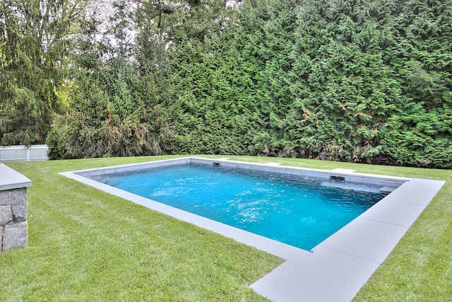 pool with a lawn and fence