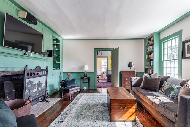 living room with built in features and dark hardwood / wood-style floors