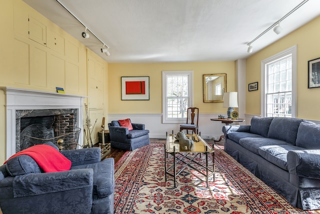 living room with a high end fireplace and track lighting