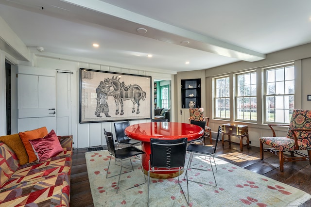 dining room with dark wood-type flooring and beamed ceiling