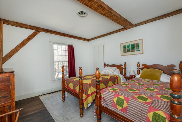 bedroom with beamed ceiling and hardwood / wood-style flooring