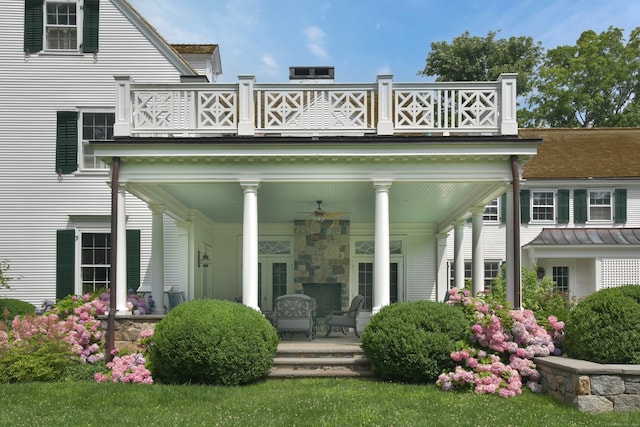 back of house featuring a balcony