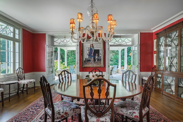 dining room with crown molding, dark wood-type flooring, and a chandelier