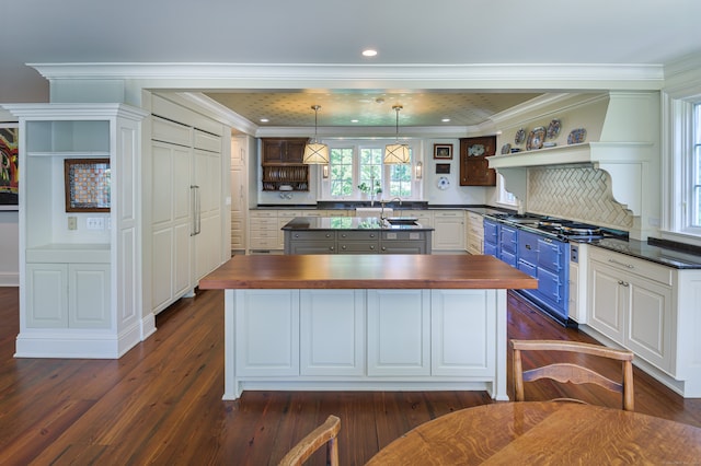 kitchen featuring blue cabinets, white cabinetry, dark wood-type flooring, pendant lighting, and wood counters