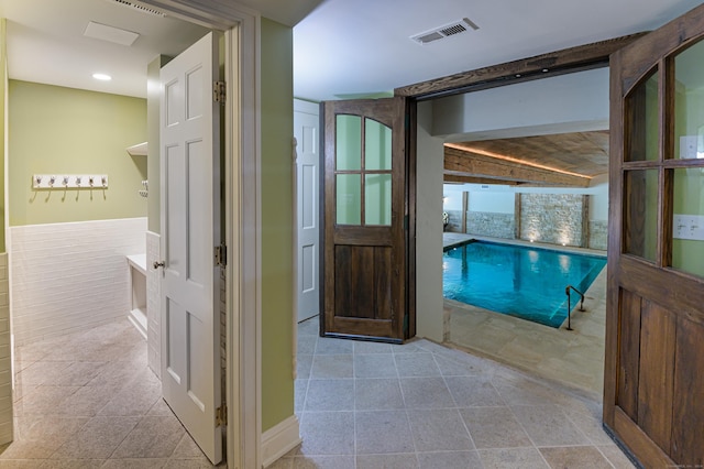 hallway with tile patterned floors, visible vents, and recessed lighting