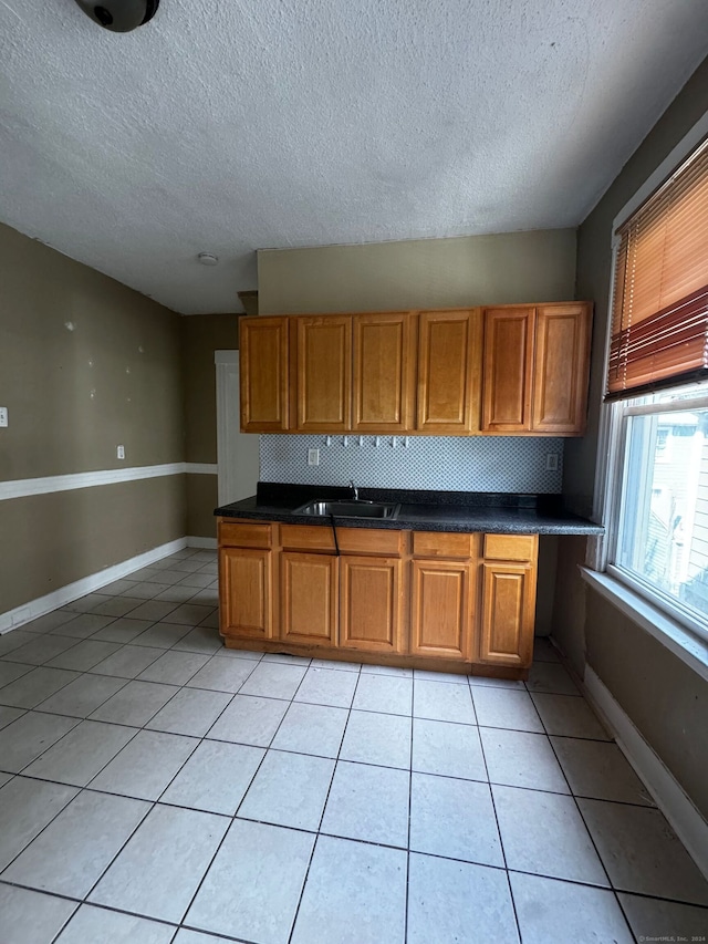 kitchen featuring light tile patterned floors and tasteful backsplash