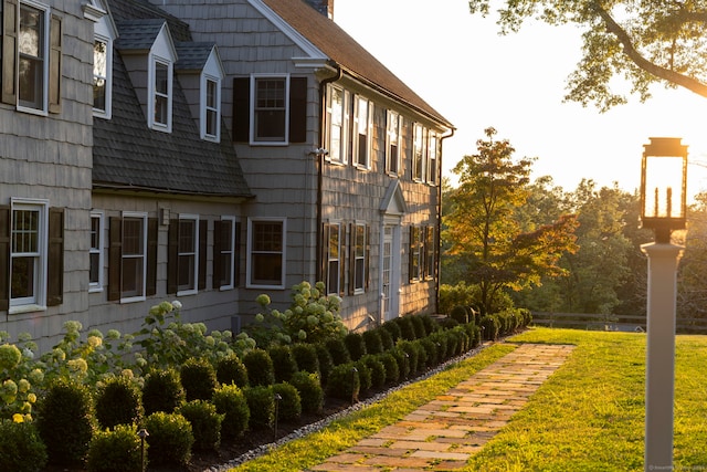 view of property exterior featuring a lawn