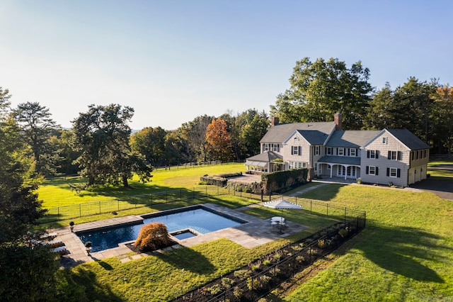 view of swimming pool featuring a patio area and a yard