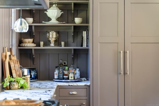 bar featuring light stone countertops