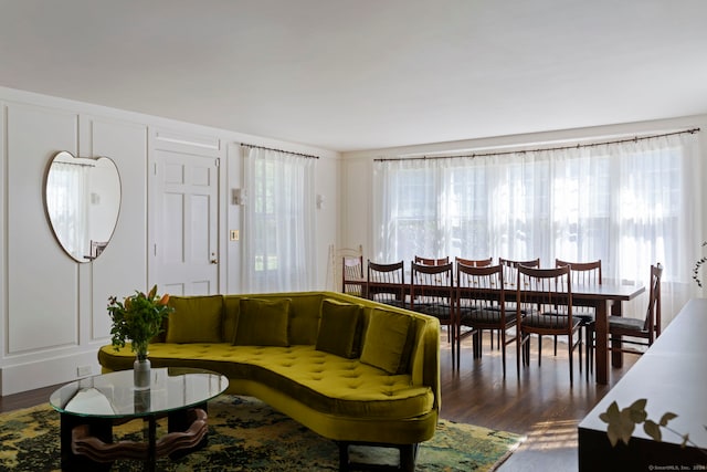 living room featuring a wealth of natural light and dark hardwood / wood-style flooring