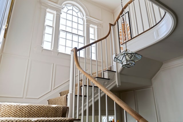 325 Old Mountain Rd, Farmington, CT 06032 - stairway featuring a decorative wall, a high ceiling, decorative columns, and ornamental molding