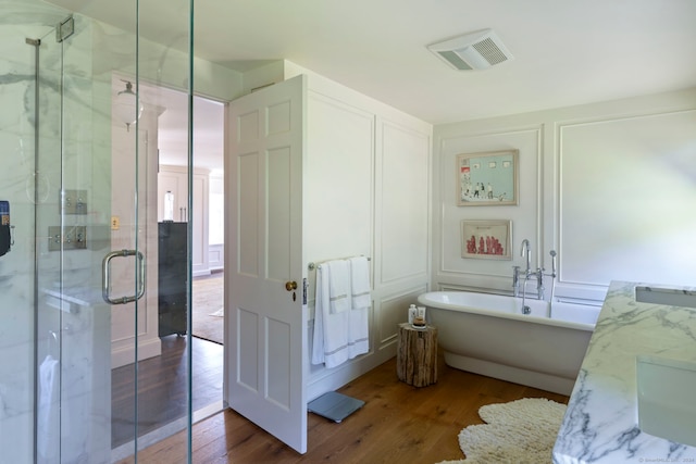 bathroom with vanity, separate shower and tub, and hardwood / wood-style floors