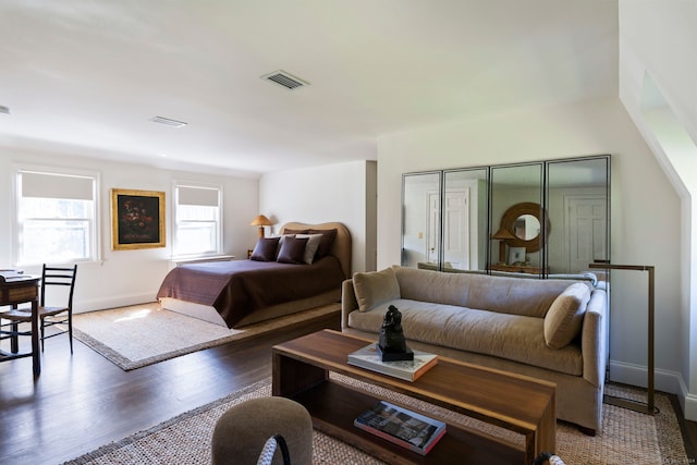 bedroom with dark hardwood / wood-style floors and a closet