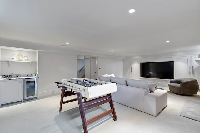 living room with light colored carpet, bar area, and beverage cooler