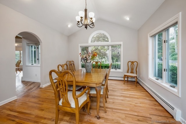 dining room featuring light wood-type flooring, lofted ceiling, and plenty of natural light