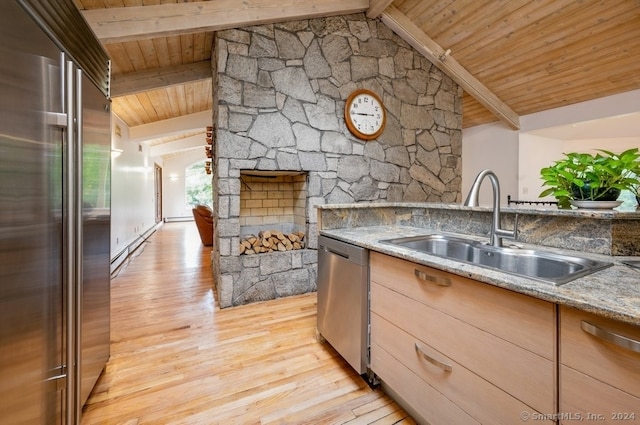 kitchen featuring lofted ceiling with beams, stainless steel appliances, light hardwood / wood-style flooring, and light stone countertops