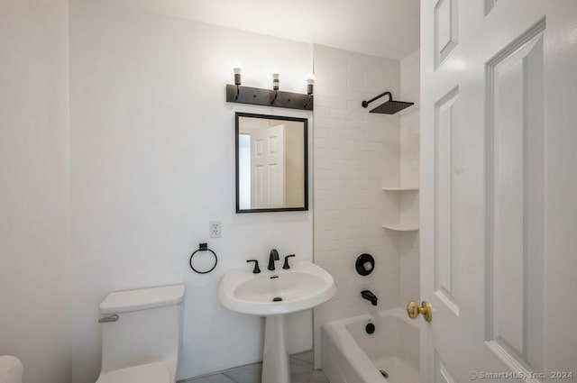 bathroom with tiled shower / bath combo, toilet, and tile patterned floors