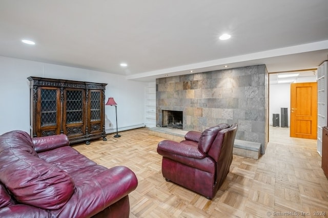 living room with a baseboard radiator, a large fireplace, and light parquet flooring