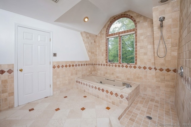 bathroom featuring independent shower and bath, tile walls, and lofted ceiling