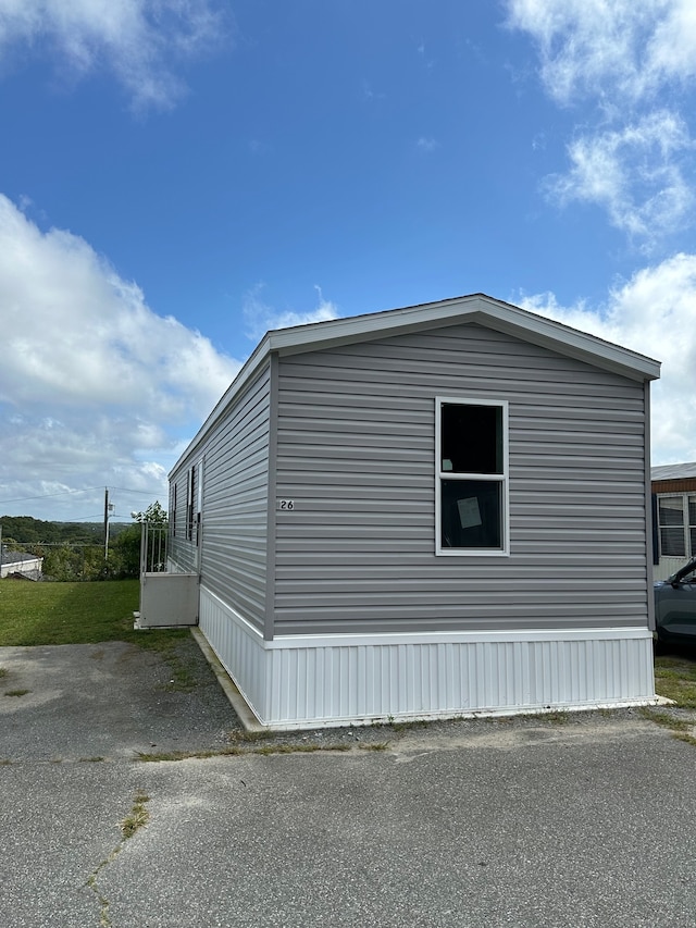 view of property exterior with a yard