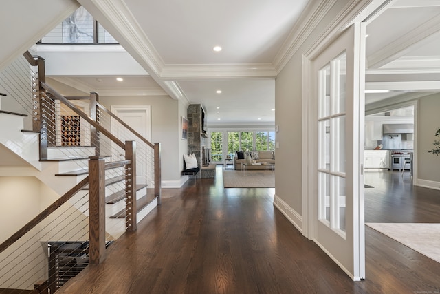 foyer entrance featuring ornamental molding and dark wood-type flooring