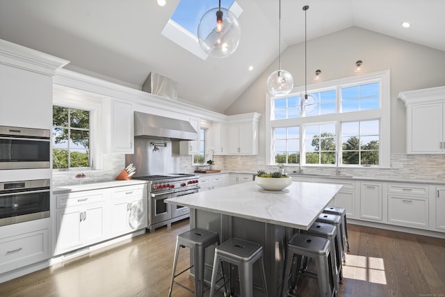 29 Rogues Rdg, Weston, CT 06883 - kitchen featuring appliances with stainless steel finishes, wall chimney exhaust hood, high vaulted ceiling, white cabinets, and decorative backsplash