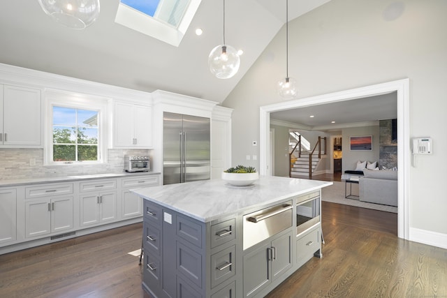 29 Rogues Rdg, Weston, CT 06883 - kitchen featuring built in appliances, a warming drawer, high vaulted ceiling, tasteful backsplash, and white cabinets