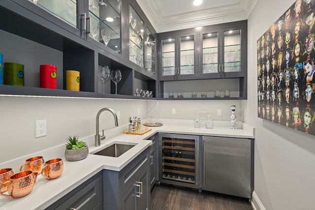 bar featuring ornamental molding, sink, beverage cooler, stainless steel refrigerator, and dark hardwood / wood-style flooring