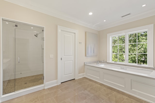 bathroom with ornamental molding and shower with separate bathtub