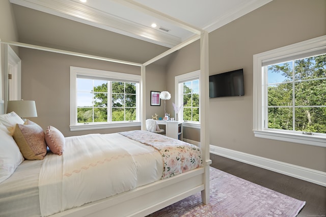 bedroom featuring crown molding and dark hardwood / wood-style floors