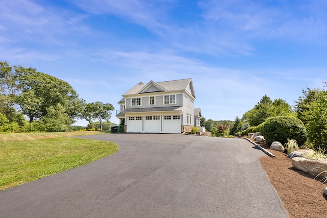 view of front of home featuring a front lawn and a garage