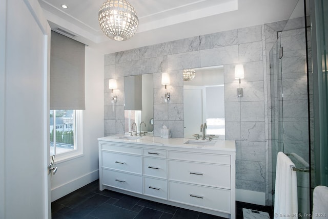 bathroom with tile patterned floors, a shower with shower door, tile walls, and vanity