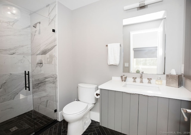 bathroom with vanity, a shower with shower door, and toilet