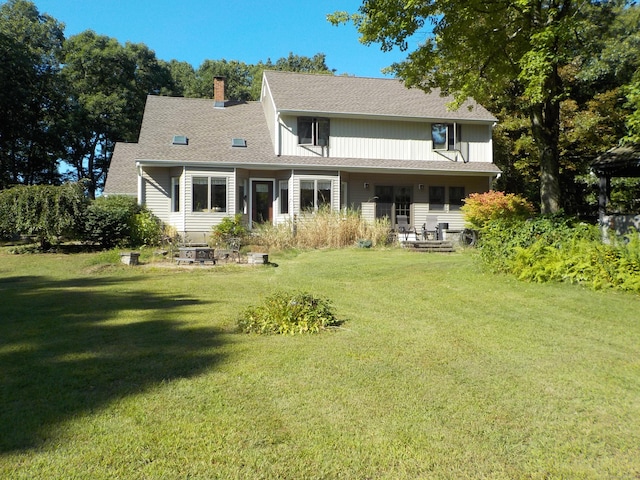 rear view of house with a lawn