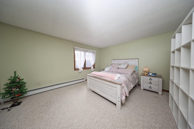 carpeted bedroom featuring baseboard heating and a textured ceiling