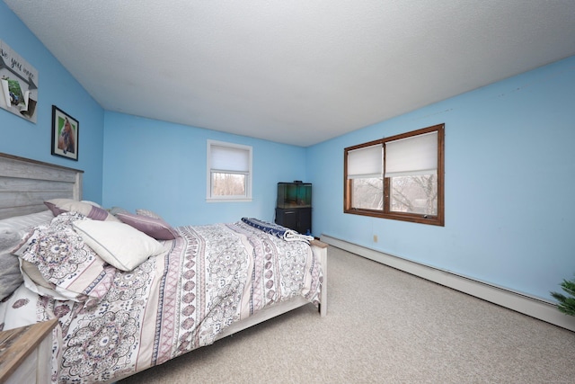 bedroom featuring carpet, a textured ceiling, and a baseboard radiator