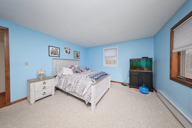 bedroom with a textured ceiling, a baseboard heating unit, and carpet flooring