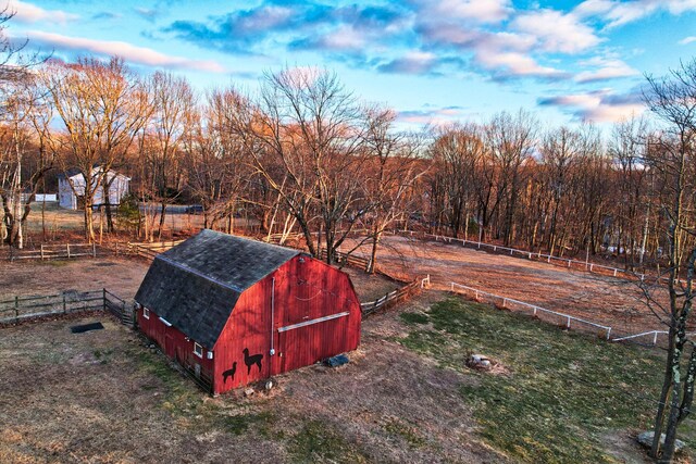 view of yard featuring a rural view and an outdoor structure