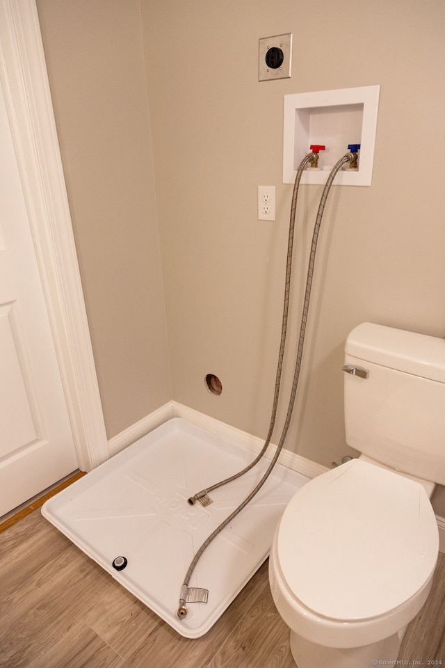 bathroom with wood-type flooring and toilet