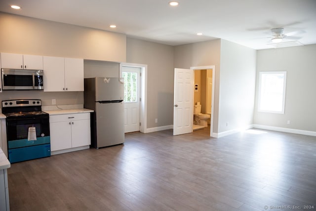 kitchen featuring appliances with stainless steel finishes, white cabinetry, ceiling fan, and dark hardwood / wood-style floors